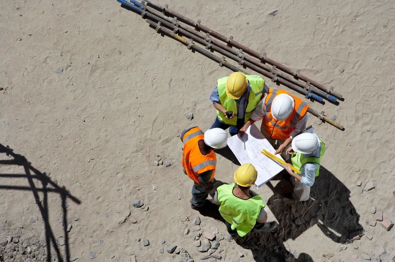 Westover crew reviewing blueprints on a construction site